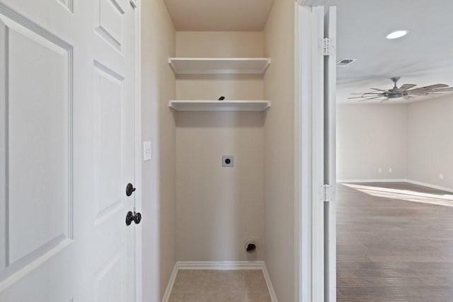laundry area featuring baseboards, laundry area, a ceiling fan, and electric dryer hookup