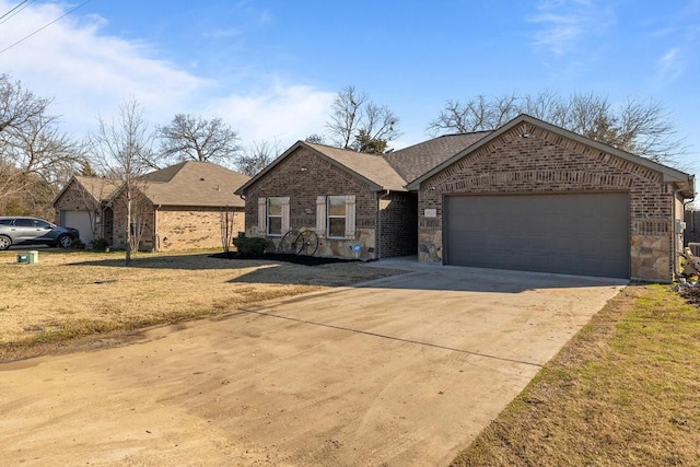 single story home with driveway, brick siding, an attached garage, and stone siding