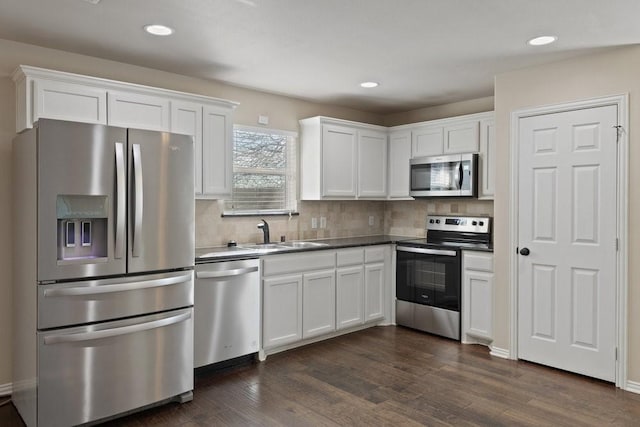 kitchen featuring white cabinetry, appliances with stainless steel finishes, tasteful backsplash, and a sink