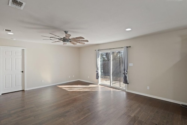 empty room with a ceiling fan, baseboards, visible vents, and wood finished floors