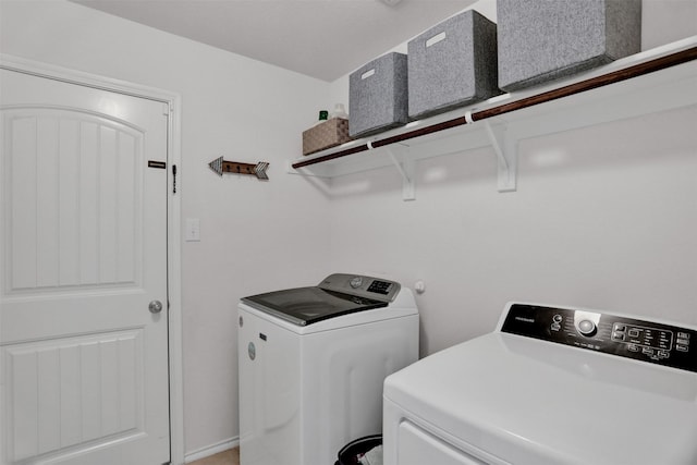 clothes washing area featuring washer and clothes dryer