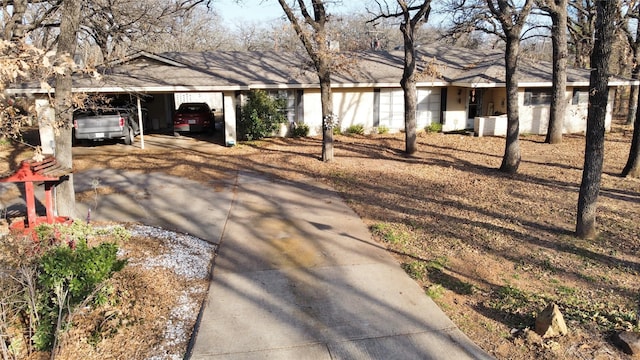 single story home featuring a carport