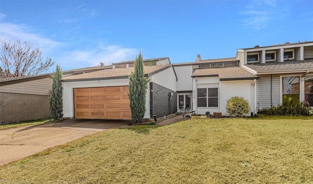 view of front of house featuring concrete driveway, roof with shingles, a front yard, and a garage