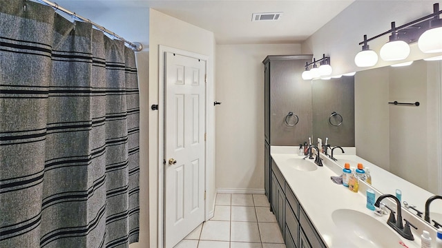 bathroom with tile patterned floors and vanity