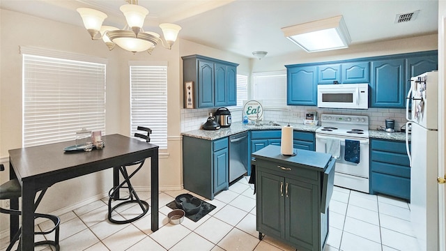 kitchen with blue cabinets, sink, tasteful backsplash, pendant lighting, and white appliances