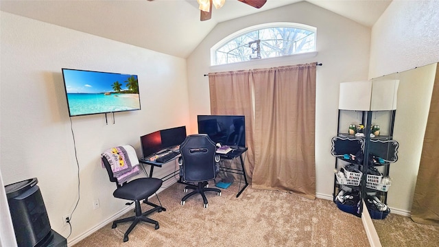 carpeted home office featuring lofted ceiling and ceiling fan