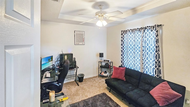 office featuring ornamental molding, carpet flooring, ceiling fan, and a tray ceiling