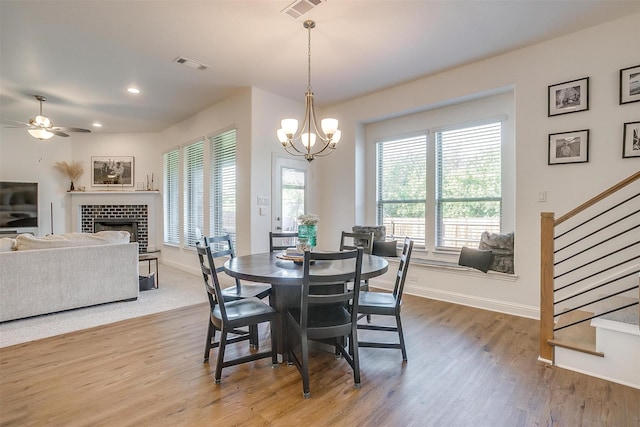 517 Ramon St, Burleson, TX 76028 - dining space with stairway, wood finished floors, a chandelier, a fireplace, and recessed lighting