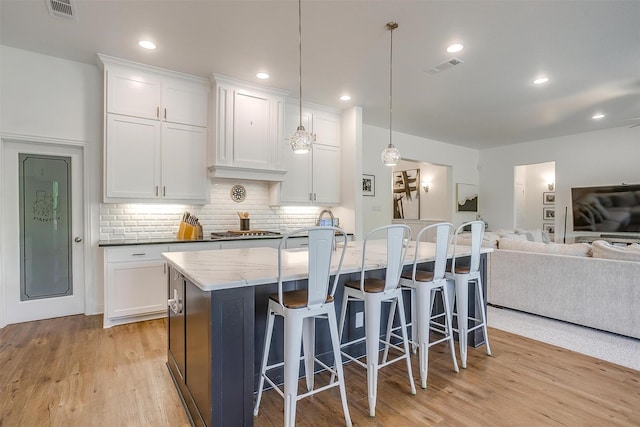 517 Ramon St, Burleson, TX 76028 - kitchen with white cabinetry, light wood finished floors, open floor plan, tasteful backsplash, and recessed lighting