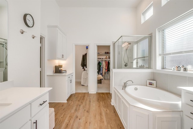 517 Ramon St, Burleson, TX 76028 - full bath featuring a stall shower, a garden tub, vanity, a spacious closet, and wood finished floors