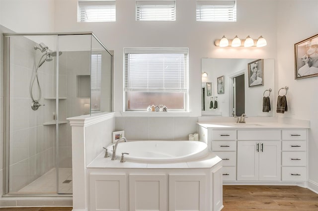 517 Ramon St, Burleson, TX 76028 - bathroom with vanity, a bath, a stall shower, and wood finished floors