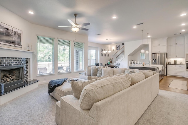 517 Ramon St, Burleson, TX 76028 - living room featuring ceiling fan, a chandelier, recessed lighting, a tile fireplace, and light carpet