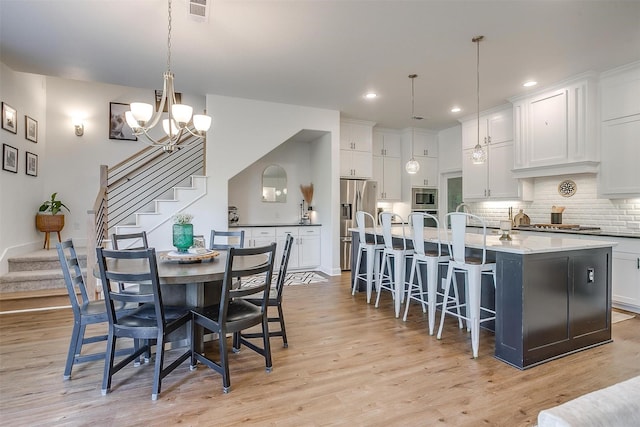 517 Ramon St, Burleson, TX 76028 - dining room with stairs, light wood finished floors, a chandelier, and recessed lighting