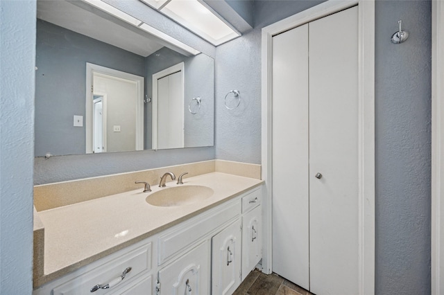 7316 Martha Ln, Fort Worth, TX 76112 - bathroom featuring vanity, a textured wall, and wood finished floors