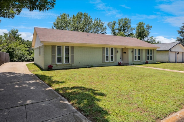 7316 Martha Ln, Fort Worth, TX 76112 - ranch-style home with brick siding, a front yard, driveway, and roof with shingles
