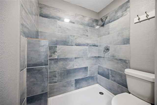 7316 Martha Ln, Fort Worth, TX 76112 - full bath featuring a tile shower, toilet, and a textured wall