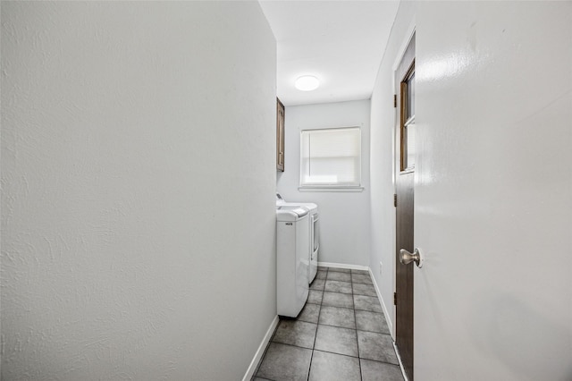 7316 Martha Ln, Fort Worth, TX 76112 - laundry area featuring washing machine and dryer, cabinet space, baseboards, and light tile patterned floors
