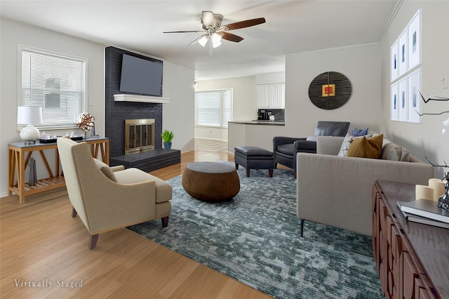 7316 Martha Ln, Fort Worth, TX 76112 - living room featuring a ceiling fan, light wood-type flooring, and a fireplace