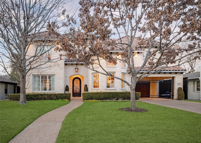 mediterranean / spanish house featuring a front yard