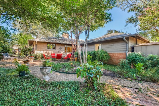 back of house with a patio