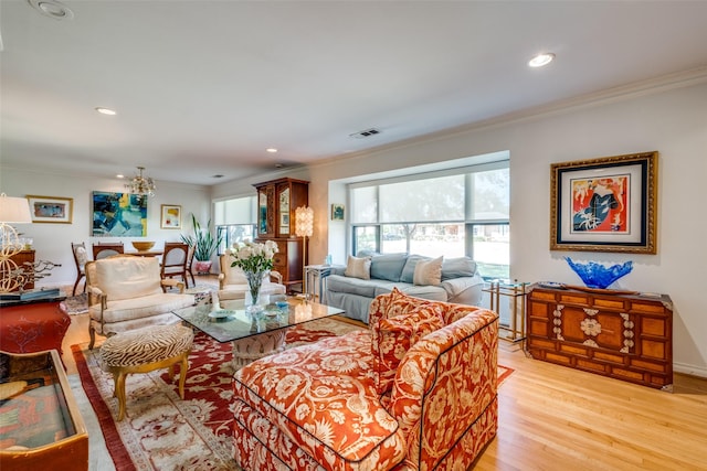 living room featuring ornamental molding and light hardwood / wood-style floors