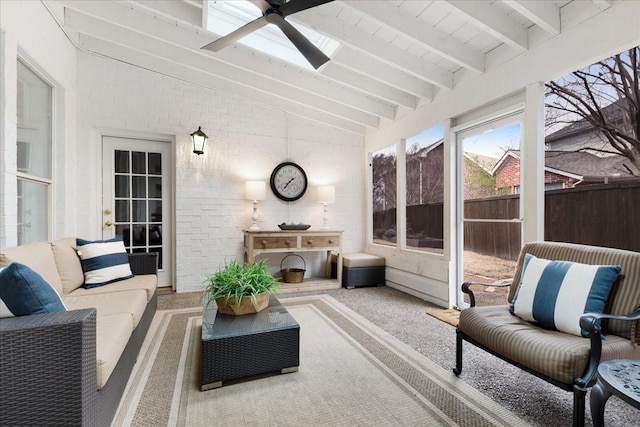 sunroom featuring vaulted ceiling with skylight and a ceiling fan