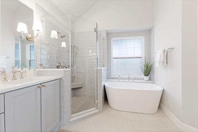 full bath with a freestanding tub, vanity, and a shower stall