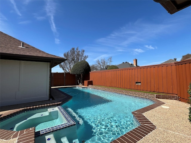 view of swimming pool featuring a pool with connected hot tub and a fenced backyard