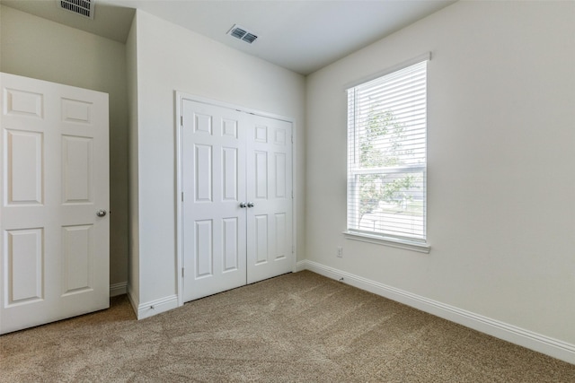 3917 Belleview Pl, Crandall, TX 75114 - unfurnished bedroom featuring carpet, visible vents, and multiple windows
