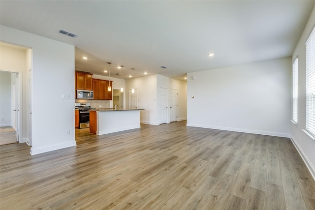 3917 Belleview Pl, Crandall, TX 75114 - unfurnished living room featuring baseboards, visible vents, light wood finished floors, and recessed lighting