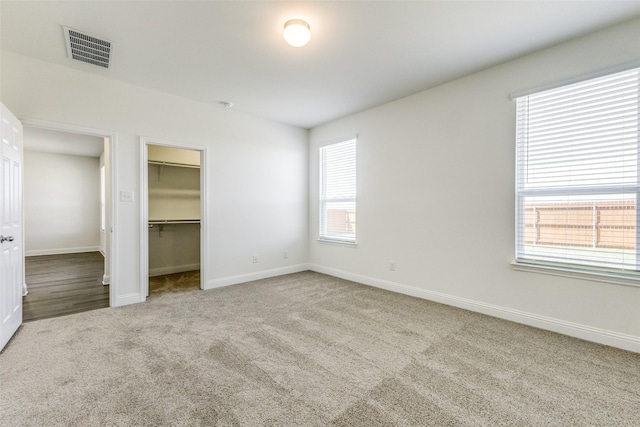 3917 Belleview Pl, Crandall, TX 75114 - unfurnished bedroom featuring a closet, a spacious closet, carpet floors, baseboards, and visible vents