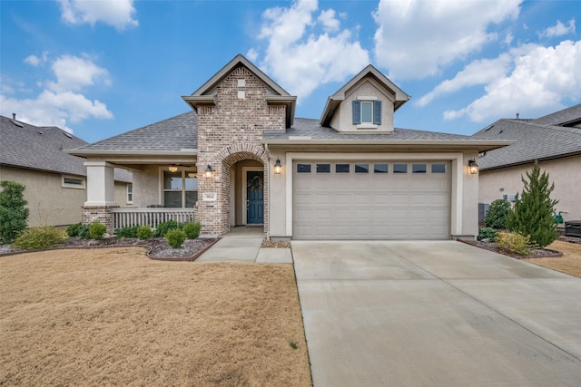 view of front of home featuring covered porch and a garage