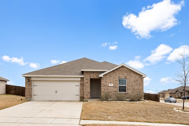 single story home featuring concrete driveway, brick siding, fence, and an attached garage