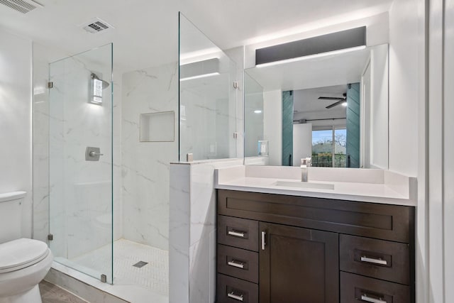 bathroom with ceiling fan, vanity, toilet, and walk in shower