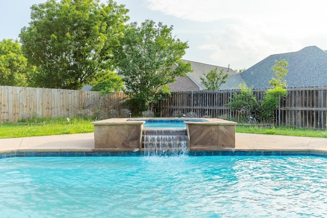 view of swimming pool with an in ground hot tub