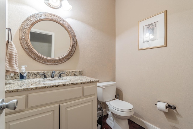 bathroom featuring toilet and vanity