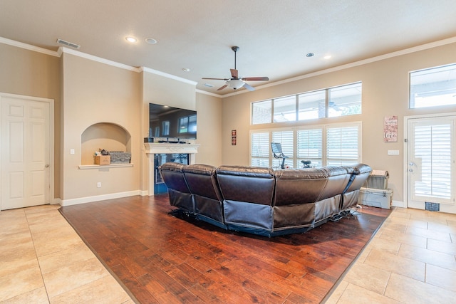 living room featuring ornamental molding, ceiling fan, and light tile patterned floors