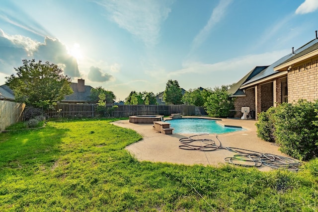 view of swimming pool featuring a yard, an in ground hot tub, and a patio area