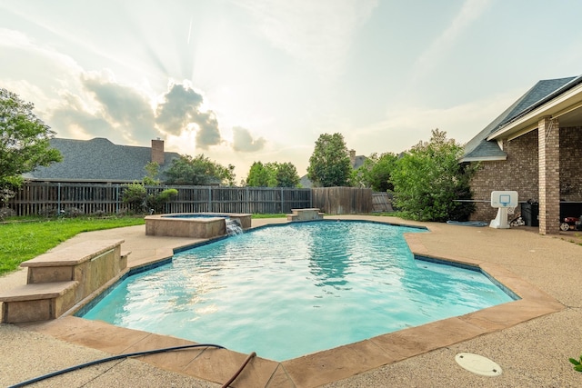 view of swimming pool with a patio, an in ground hot tub, and pool water feature