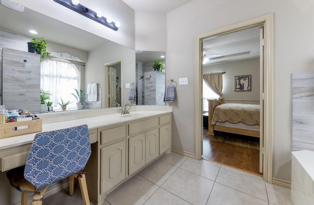 bathroom with tile patterned floors, vanity, and ceiling fan