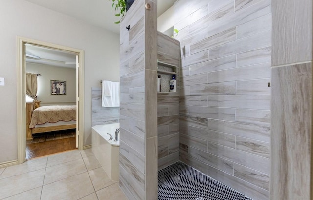 bathroom featuring plus walk in shower and tile patterned flooring