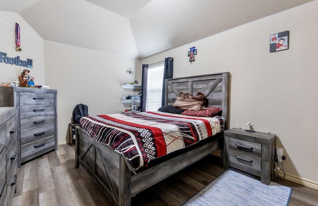 bedroom with vaulted ceiling and wood-type flooring