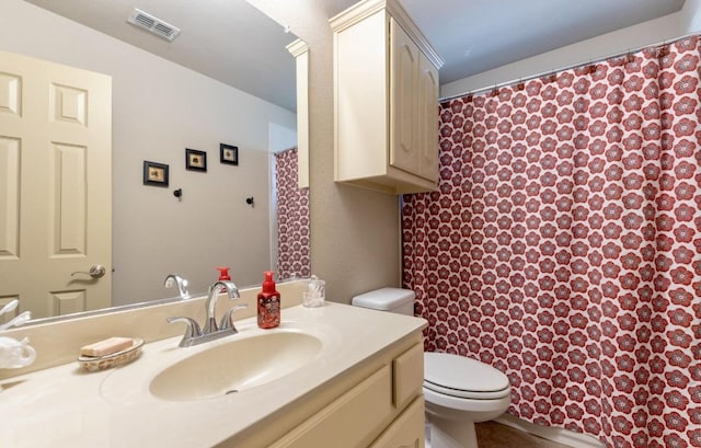 bathroom with toilet and vanity