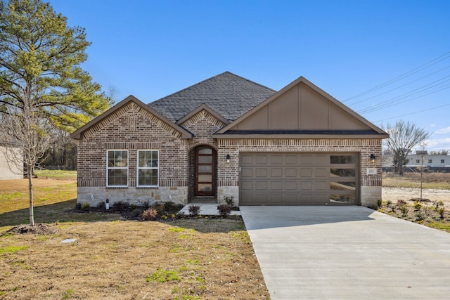 view of front of home with a garage and a front yard