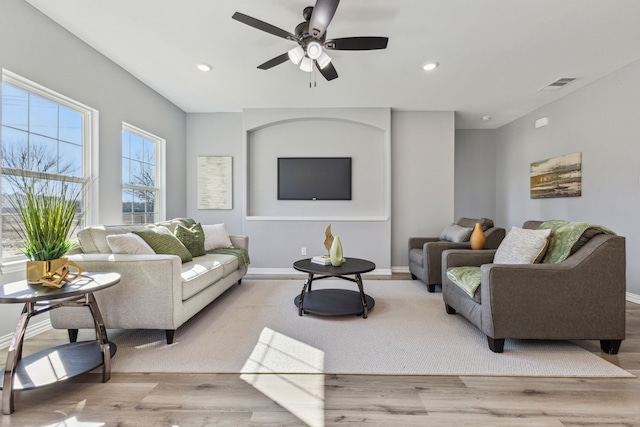 living room with ceiling fan and light hardwood / wood-style floors