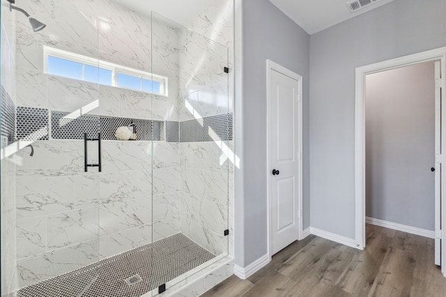 bathroom featuring hardwood / wood-style flooring and a shower with door