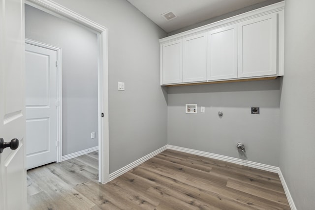 laundry room featuring cabinets, hookup for an electric dryer, gas dryer hookup, hookup for a washing machine, and light hardwood / wood-style floors