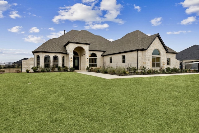 french country home featuring a front lawn