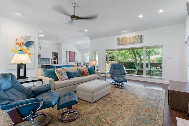 living room featuring lofted ceiling, plenty of natural light, recessed lighting, and wood finished floors