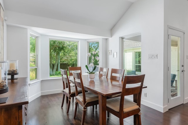 dining area with dark wood-type flooring, vaulted ceiling, and baseboards